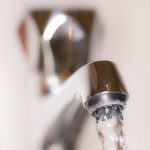 Kitchen tap with water running